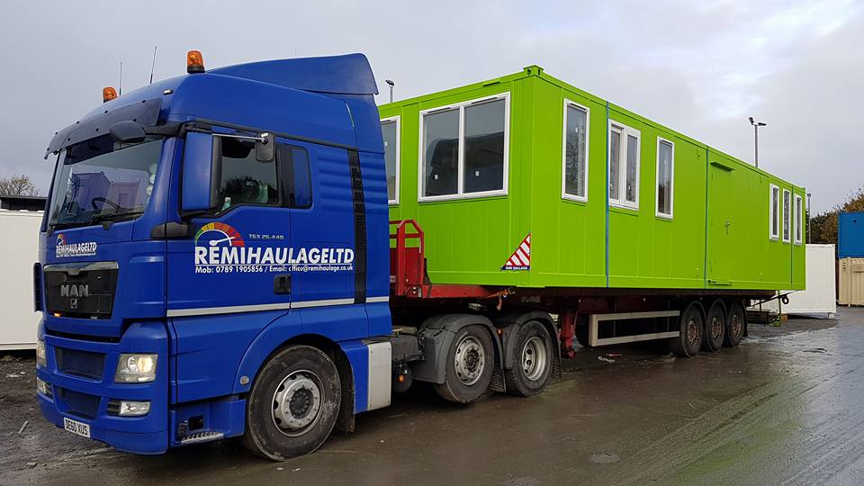 Blue Remi Haulage truck with a green cabin