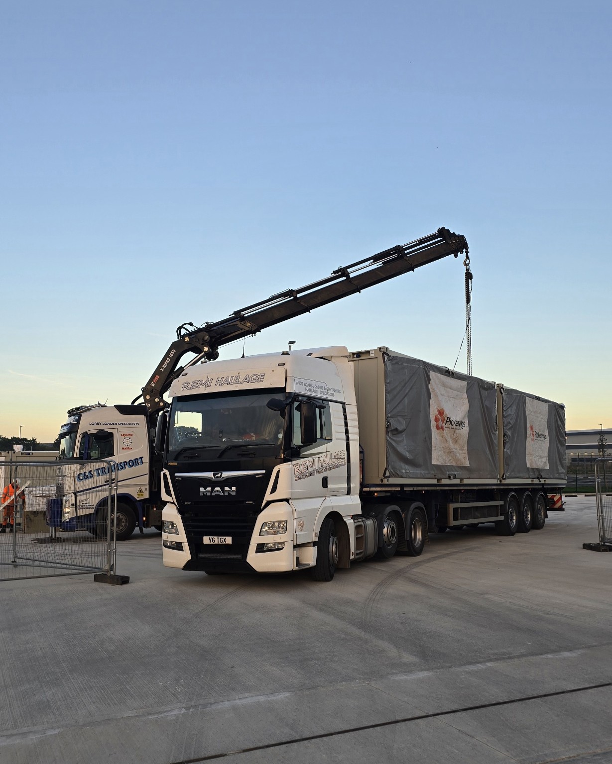 Remi Haulage truck carrying modular units during crane loading operations