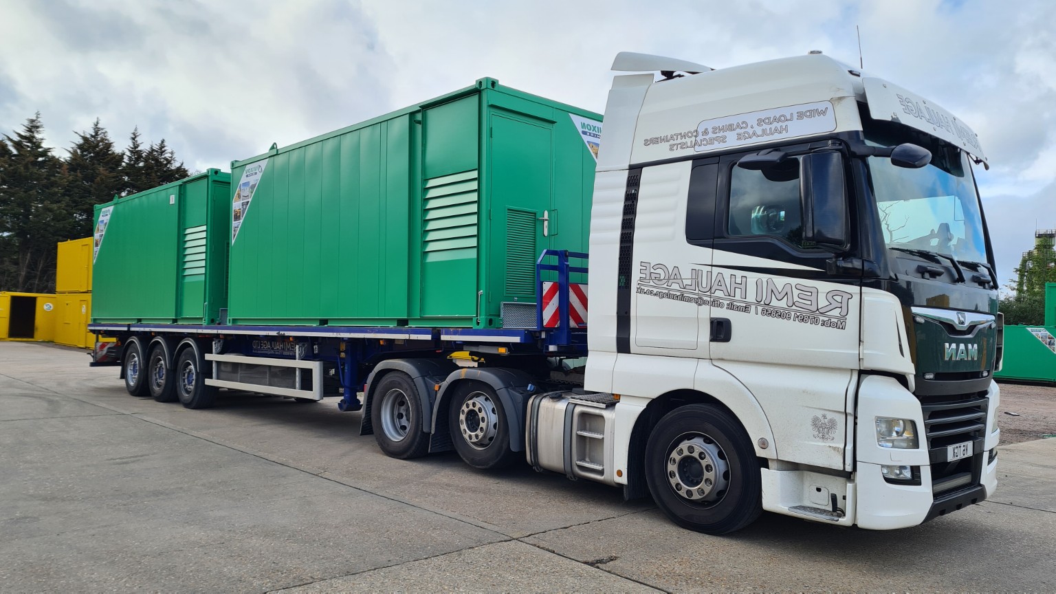 Remi Haulage truck transporting a large green unit